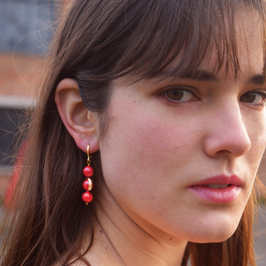 Coral gemstone asymmetric gold huggie earrings | by Ifemi Jewels